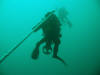 Diver with scooter on his way up the shotline